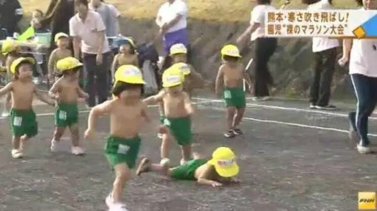跑步期间，有孩子不慎跌倒，但立马就爬起来继续比赛，也有不少小朋友冻得大哭，但还是一边流着眼泪一边在大人的鼓励下跑向终点。图为跌倒的孩子。