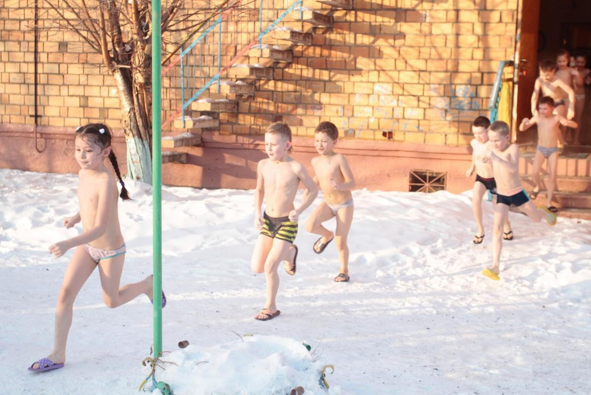 图为幼儿园的孩子赤身在雪地里。